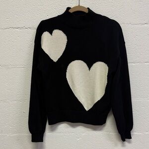 Chic Black Turtleneck Sweater with Cream Heart Accents